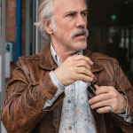 Old-Guy-2025-Movie-Christoph-Waltz-Brown-Jacket